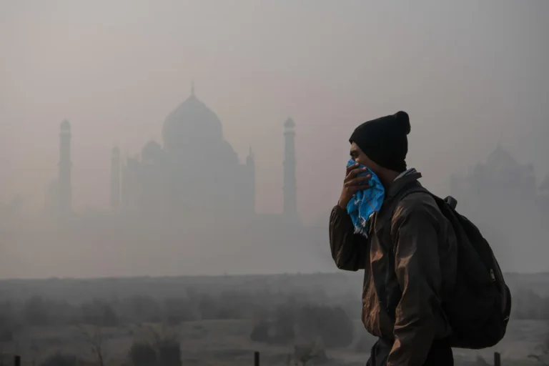 A man using handkerchief as mask to cover its face during air pollution.